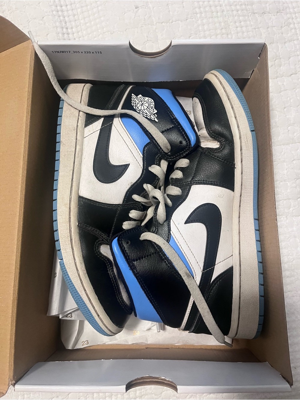 Jordan 1 Mid in Black, White & University Blue